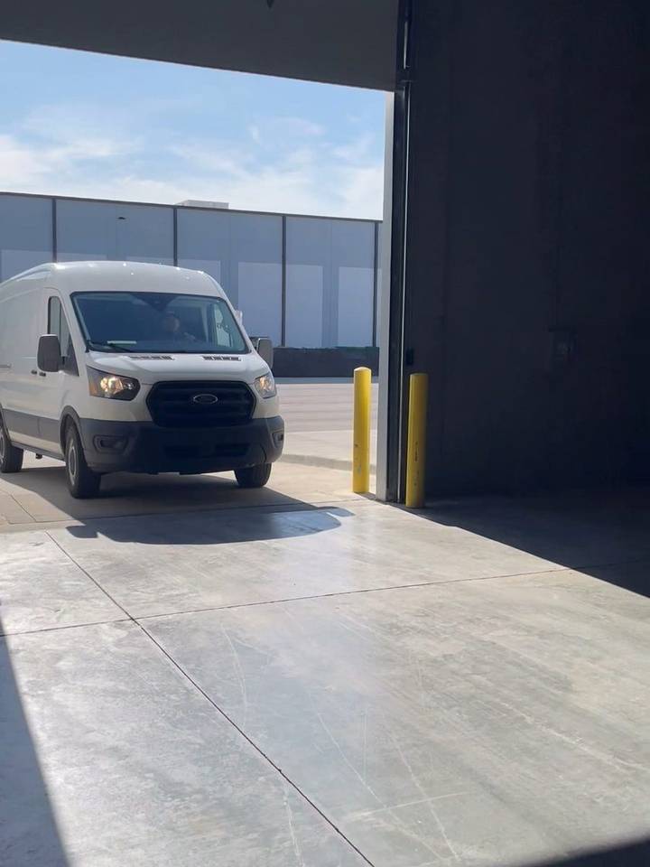 A delivery van backing into the Trade Receiving drive-in bay in Olathe, Kansas